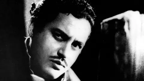 A black and white photo of Guru Dutt