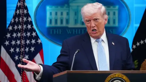 Donald Trump speaking at the podium on 6 April. 