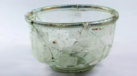 Headland Archaeology A glass Roman cup with signs of cracks and repair