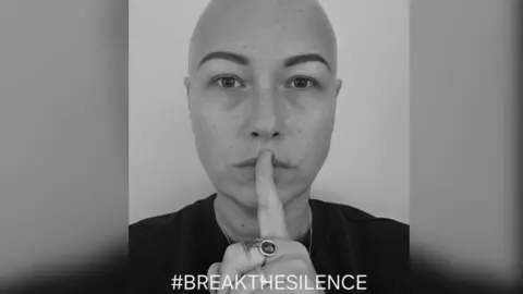 @Charlotteamyphotography Black and white close up of a woman with a finger on her lips and the hashtag breakthesilence