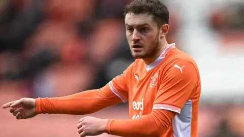 Elliot Embleton gestures while playing for Blackpool against Birmingham City