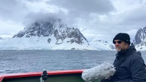 Michael Begg Michael Begg standing in Antarctica while recording and filming 