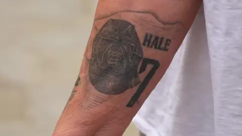 Hale's tattoo on her left arm of her team number, 7.
