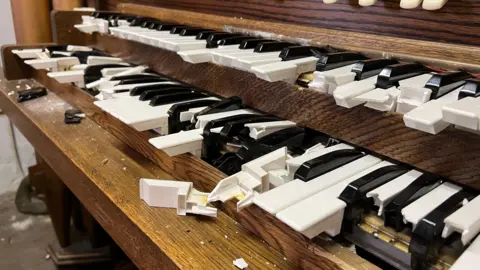 Stuart Woodward/BBC Broken black and white keys in a wooden church organ