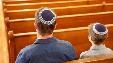 Getty Images Two people in a synagogue