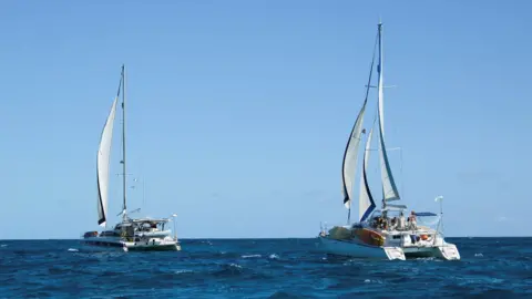 The sailboats Friendship and Tigger Moth, carrying humanitarian aid for Cuba and crewed by activists taking part in the Nuestra America Convoy flotilla, depart Isla Mujeres, in Isla Mujeres, Quintana Roo state, Mexico.