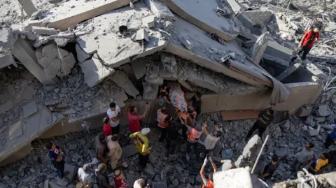 epa people remove a covered body from the rubble of a missile-hit house in khan younis on 2 october.