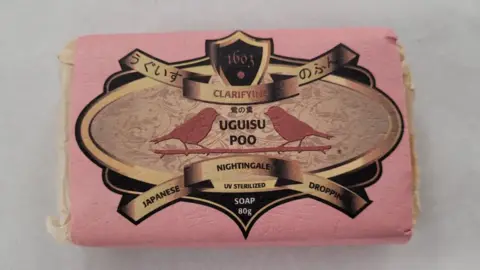 Thackray Museum of Medicine A bar of soap in pink and white packaging. On the cover it reads Uguisu Poo Japanese Nightingale Droppings