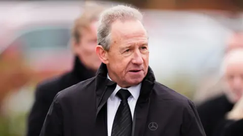 PA Media John McGovern arriving at the funeral of John Robertson