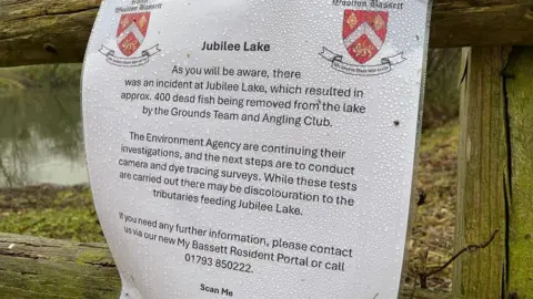 Laminated sign at the lake from the council explaining the environment agency testing.