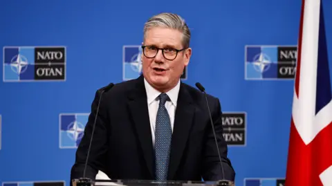 EPA Keir Starmer speaking at a Nato press conference next to a Union Jack