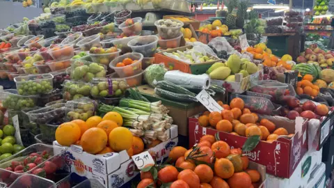 A fruit stall at Coventry Market, pictured in February 2023. There are lots of different types of fruit in bowls and boxes. 