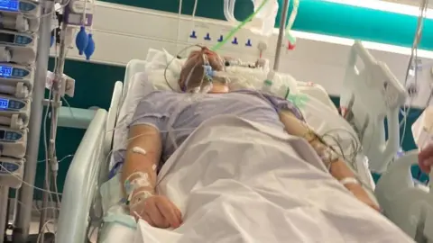 Supplied A man in a hospital bed with breathing apparatus on his face
