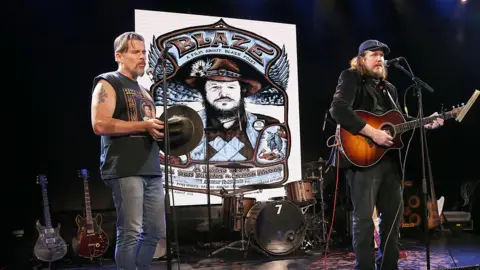 Getty Images Ethan Hawke (left) and Ben Dickey performing at the afterparty for the screening of the biopic Blaze, in Austin, Texas in 2018