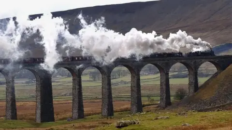 A steam train crossing a viaduct in the North York Moors. 