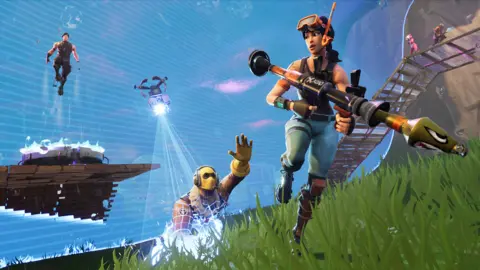 Epic Games Artwork for Fortnite shows a chaotic scene. A female character carrying an oversized rocket launcher and wearing a mask and snorkel looks over her shoulder as a pursuer in a yellow balaclava is caught up in a tractor beam. In the background a third character appears to levitate above a floating platform.