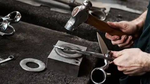 Ernest Wright A worker at Ernest Wright puts finishing touches to a pair of shears.