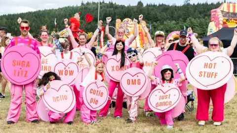 Paul Campbell Festival-goers dressed as Love Heart sweets