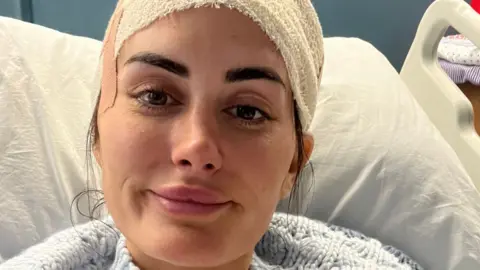 Lauren Macpherson in hospital with a bandage on her head