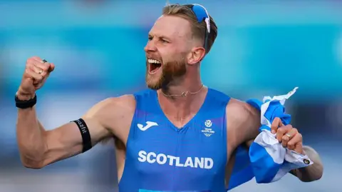 Scotland's Josh Kerr celebrates winning the men's mile at the Commonwealth Games