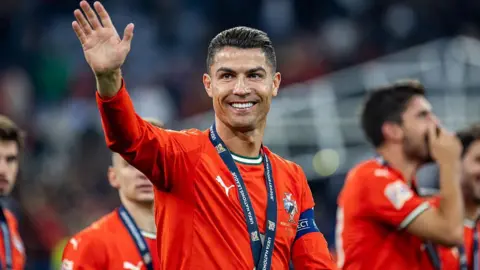 Cristiano Ronaldo smiling with his Nations League winner's medal around his neck.