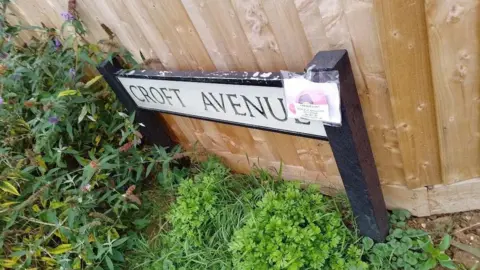 Kidlington Women's Institute A knitted elephant attached to a street sign for Croft Avenue