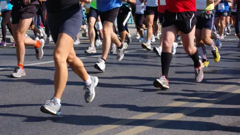 Getty Images Runners taking part in a 10k race