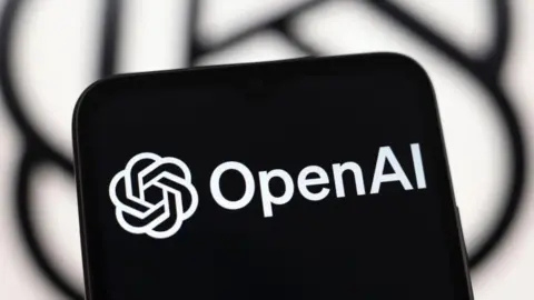 Getty Images A tablet screen with the words "OpenAI" and its logo in black and white