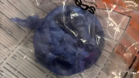 Cambridgeshire Constabulary Drugs in an evidence bag, showing something wrapped in blue.