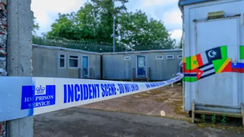 Getty Images An "incident scene - do not enter" tape across part of the detention centre 
