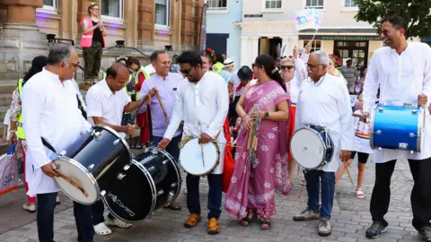 Luke Tomlinson Six people with drums stand outside Ipswich Town hall.
