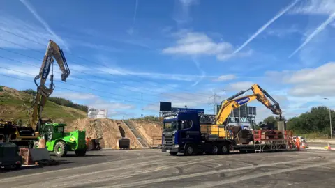 Diggers wait at the M62 bridge replacement construction site ready to start work 