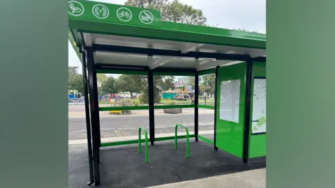 Central Bedfordshire Council  Two green cycle rails inside a bus shelter