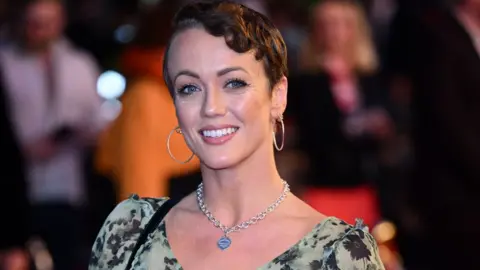 Getty Images Lauren Oakley, wearing a green and black floral dress, attends the Doctor Jekyll world premiere at Odeon Luxe Leicester Square on October 11, 2023 in London, England