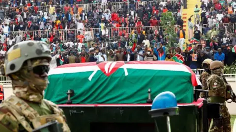 Reuters An armed soldier guard a coffin of Raila Odinga, which is draped in Kenyan flag
