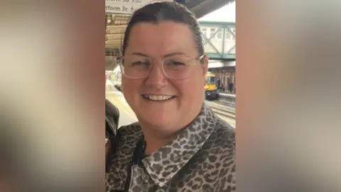 Rebecca Butler standing on a train platform in Nottingham
