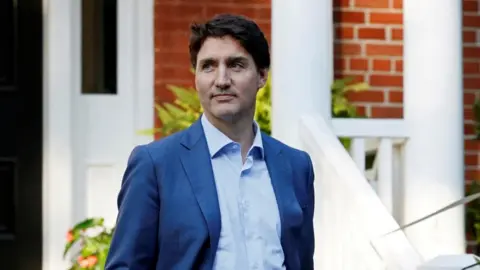 Canada's Prime Minister Justin Trudeau waits for the arrival of NATO Secretary-General Jens Stoltenberg at Rideau Cottage, Ottawa, Ontario, Canada