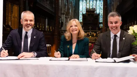 West Yorkshire Combined Authority West Yorkshire Mayor Tracy Brabin, South Yorkshire Mayor Oliver Coppard and York and North Yorkshire Mayor David Skaith sit at a table and sign plans.