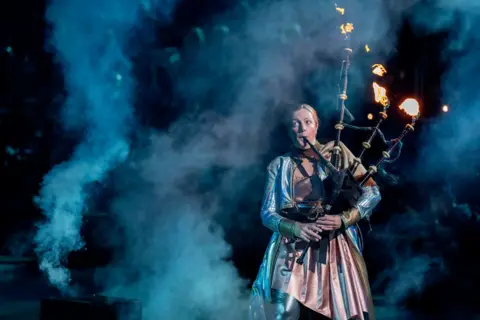 Jane Barlow/PA Media A piper playing the Highland Rave during the Royal Edinburgh Military Tattoo preview evening at Edinburgh Castle. 1 August 2024