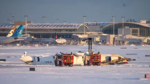 A Delta plane on its side after a crash in Toronto