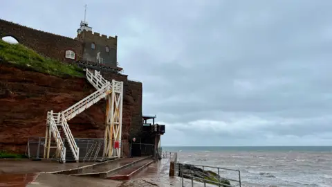 The Jacob's Ladder white steps from the beach to the Clock Tower and Connaught Gardens with fencing around the base of the steps and the sea to the right.