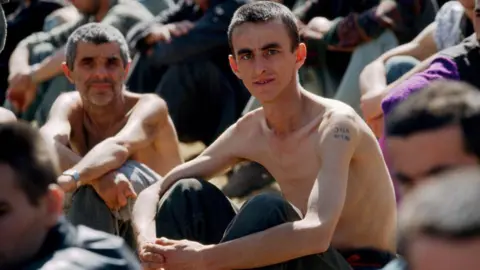 Sygma via Getty Images Emaciated prisoners at a Bosnian Serb camp in 1992