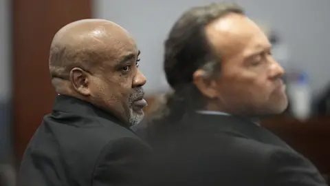 Getty Images Duane Davis, left, looks on during his murder trial, related to the 1996 killing of rapper Tupac Shakur, at the Clark County District Court at the Regional Justice Center in Las Vegas, Nevada, on 18 August 2026.
