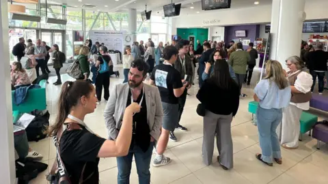 A crowd of people in a cinema foyer