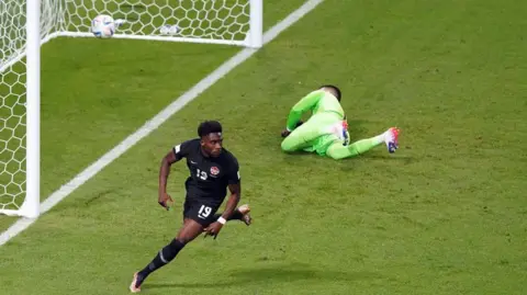 Canada's Alphonso Davies celebrates after scoring the opening goal of a 2022 World Cup match against Croatia

