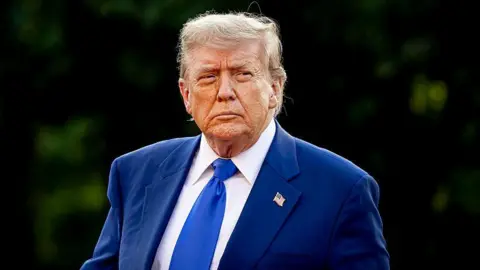 President of the United States Donald Trump wearing a blue suit and a blue tie at the NATO summit in June 2024.