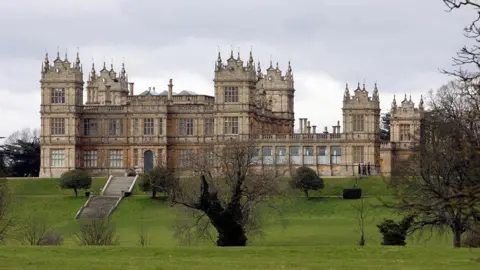 PA Media A large stately home, Mentmore Towers sits on a green under a grey sky