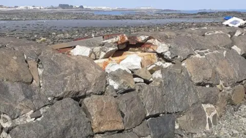 Guernsey Water A damage sewer pipe. Granite rocks used to protect the pipe and steel covers have been ripped off the structure by stormy weather.