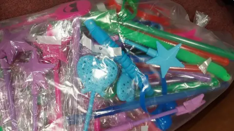 A bag of toys including colourful wants and glowsticks that were taken away