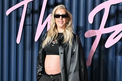 Getty Ellie goulding in black jacket, crop top and dark glasses, revealing her baby bumb